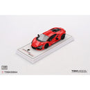 a red toy car on a white surface