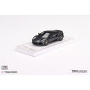 a black toy car on a white surface