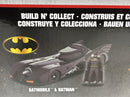 a box with a toy car and a batman figure