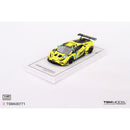 a yellow toy car on a white surface