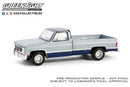 a silver and blue pickup truck