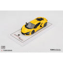 a yellow toy car on a white surface