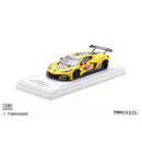 a yellow race car on a white stand