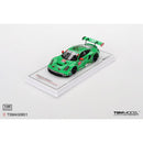 a green toy car on a white surface