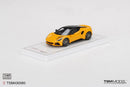 a yellow toy car on a white surface