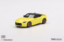 a yellow toy car on a white background