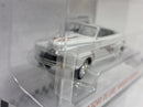 a white toy car in a plastic box