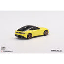 a yellow toy car on a white background