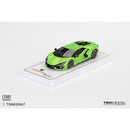 a green toy car on a white surface