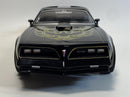 a black toy car with a gold design on it