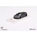 a grey toy car on a white surface
