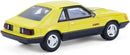 a yellow toy car with black stripes