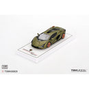 a green toy car on a white surface