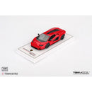 a red toy car on a white surface