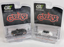 two plastic toy cars in packaging