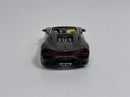 a black toy car on a white surface