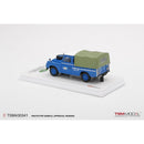 a blue truck with a green cover