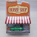 a green toy car in a plastic package