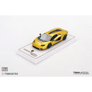 a yellow toy car on a white surface