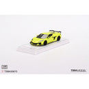 a yellow toy car on a white surface