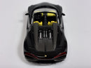 a black toy car with yellow seats