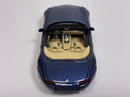 a blue toy car with tan seats