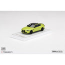 a green toy car on a white surface
