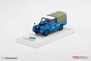 a blue toy truck on a white surface