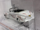 a white toy car in a plastic case