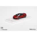 a red toy car on a white surface