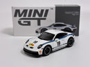 a white toy car next to a box
